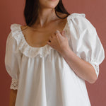 white shift dress with ruffled neckline